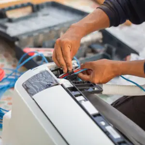 hvac technician repairing a/c unit